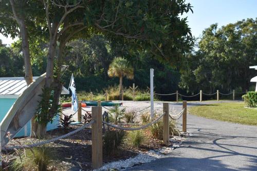 a rope fence with a slide in a park at Pinecraft Blue Heron Tiny Home in Sarasota