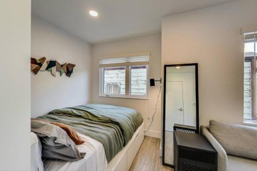 um quarto com uma cama, uma janela e um espelho em Brand New Stylish Studio Suite Near Downtown em Oakland
