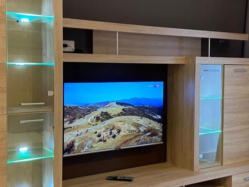 a tv in a wooden entertainment center with a television at Atlas-Résidence by Rent-Inn in Rabat