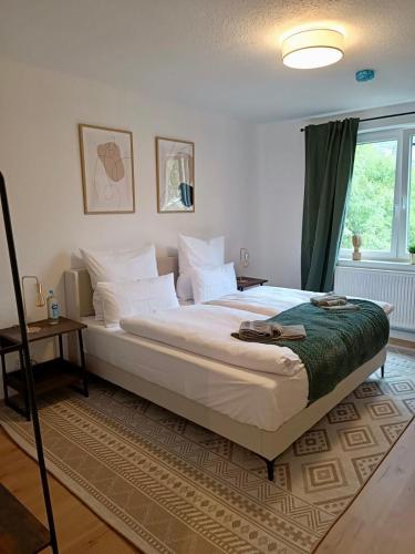 a bedroom with a large bed and a window at Bright and central with 2 beds incl workspace in Bochum