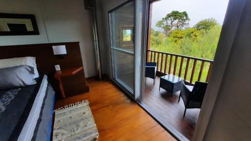 a room with a bed and a balcony with a view at Nairandey in La Pedrera