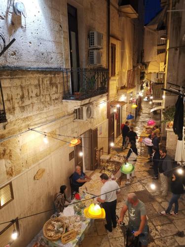 an overhead view of a group of people preparing food in an alley at La Casa delle Tradizioni in Bari
