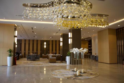 a large lobby with a chandelier in a hotel at Best Western Plus Danat Almansak Hotel in Abha