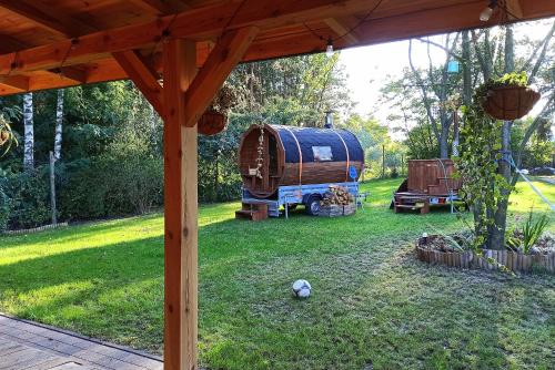 an rv and a tent in a yard at Dom imprezowy z noclegami Dziecinów in Dziecinów