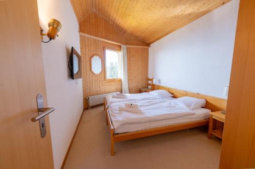 a small bedroom with a bed in a room at Eden Resort Anzère in Anzère