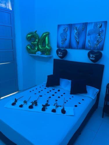 a blue bedroom with a bed with grapes on it at Hotel San Martin Plaza in Villeta