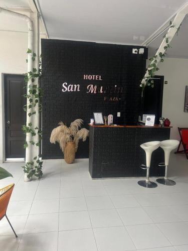 a room with a display with a teddy bear on a wall at Hotel San Martin Plaza in Villeta
