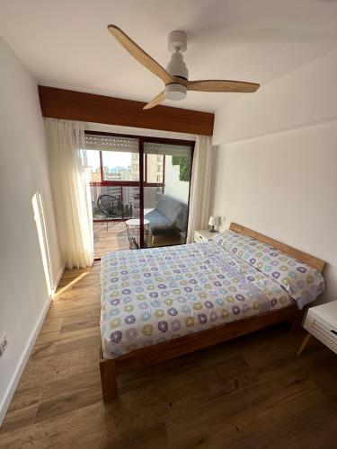 a bedroom with a bed and a ceiling fan at Benidorm beach, playa de Benidorm in Benidorm