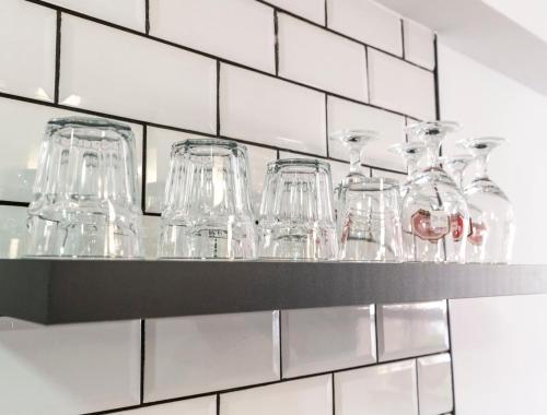 a shelf filled with glasses on a wall at Benidorm beach, playa de Benidorm in Benidorm