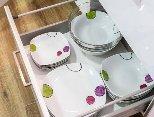 four bowls and plates on a shelf at Benidorm beach, playa de Benidorm in Benidorm