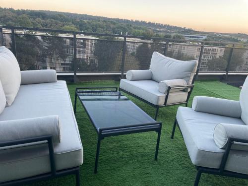 three couches and a coffee table on a balcony at Best View Terrace in Târgu-Mureş