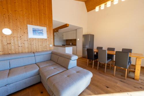 a living room with a couch and a table at Eden Resort Anzère in Anzère