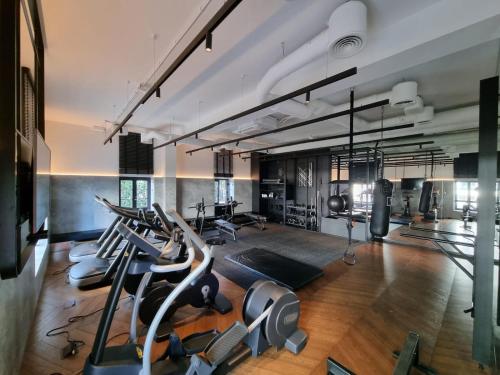 a gym with treadmills and elliptical machines at Portova Apartament in Gdynia