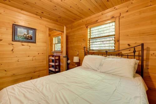 a bedroom with a bed in a log cabin at Hot Tub and Furnished Porch Balsam Grove Cabin in Balsam Grove