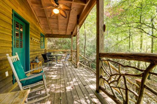 a porch of a cabin with chairs and a table at Hot Tub and Furnished Porch Balsam Grove Cabin in Balsam Grove