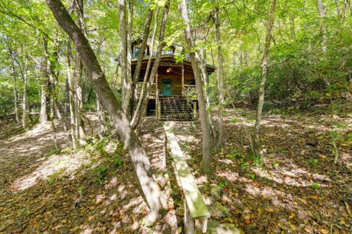 a tree house in the middle of the woods at Hot Tub and Furnished Porch Balsam Grove Cabin in Balsam Grove