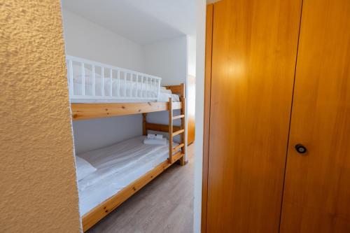 a room with two bunk beds in a room at Eden Resort Anzère in Anzère
