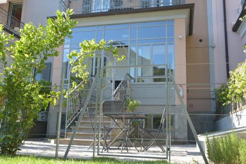 a table and a chair in front of a building at Residenza Cece' in Lecco