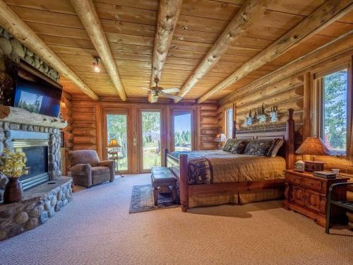 a bedroom with a bed and a fireplace at Sun Valley Cabin in Grand Lake