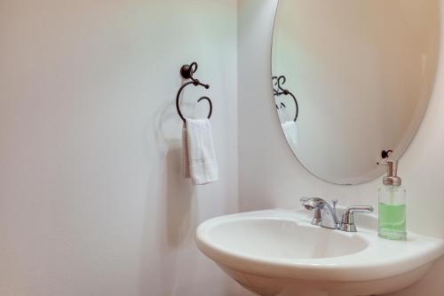 a bathroom with a sink and a mirror at Lake Minocqua Condo with Shared Fire Pit! in Minocqua