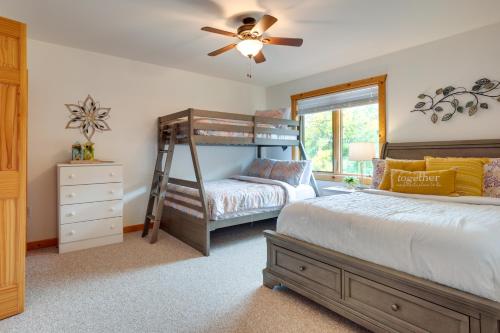 a bedroom with two bunk beds and a ceiling fan at Lake Minocqua Condo with Shared Fire Pit! in Minocqua