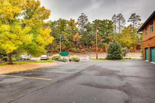 an empty parking lot next to a building at Lake Minocqua Condo with Shared Fire Pit! in Minocqua