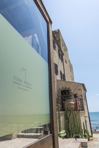 a reflection of a building in a glass window at Torre Mozza - Dimora d' Epoca in Follonica