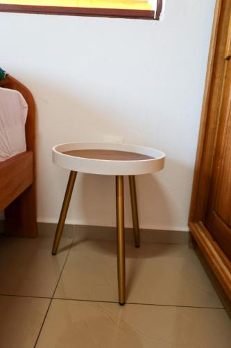 a small white table with wooden legs in a room at MANA - SRFB 5 in Mana