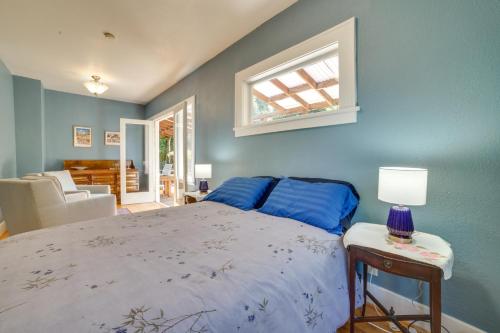 a blue bedroom with a bed and a table with a lamp at Historic Seattle Vacation Rental in Seward Park! in Seattle