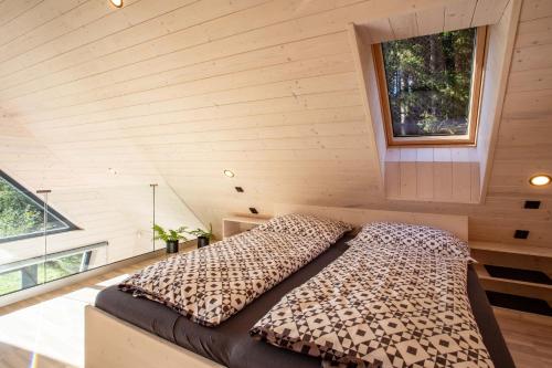 a bedroom with a leopard print bed in a tiny house at Chalet Belveder Železná Ruda in Železná Ruda