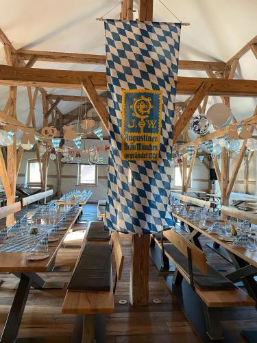 a large dining room with tables and a checkered flag at Landgasthaus zur Linde in Pleiskirchen