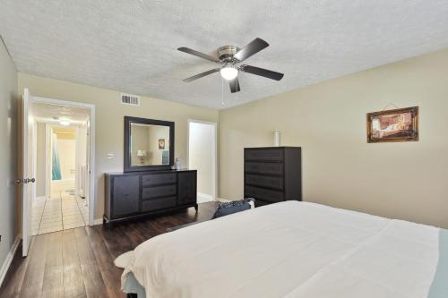 a bedroom with a bed and a ceiling fan at Convenient Athens Condo with Patio about 3 Mi to UGA! in Athens