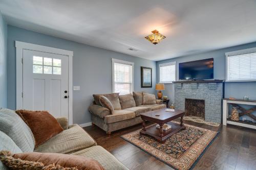 a living room with a couch and a fireplace at 1001 Sevier Bungalow 2 Mi to Neyland Stadium! in Knoxville