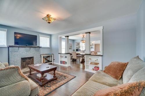 a living room with a couch and a fireplace at 1001 Sevier Bungalow 2 Mi to Neyland Stadium! in Knoxville