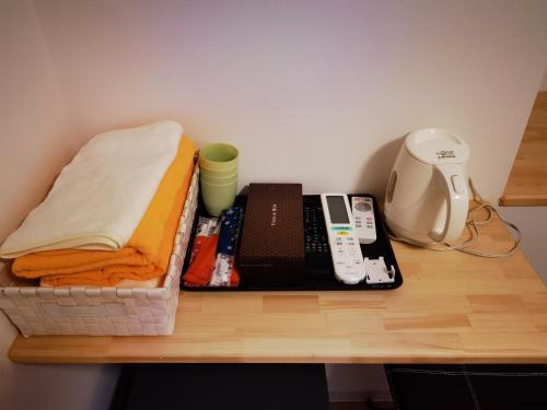 a wooden table with a shelf with a sewing machine at belle via tokyo - Vacation STAY 58509v in Tokyo