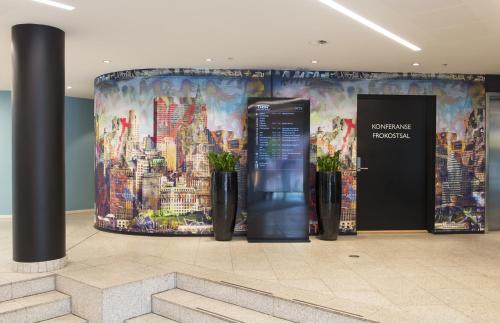 a wall in a building with a mural of a city at Thon Hotel Vika Atrium in Oslo