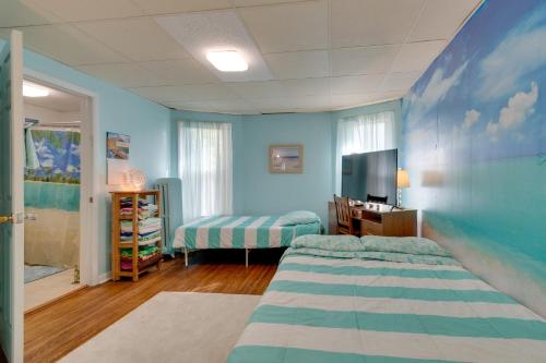a room with two beds and a tv in it at Idyllic Rochester Apt with Hot Tub 2 Miles to Dtwn! in Rochester