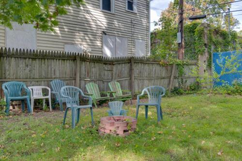 a group of chairs in a yard next to a fence at Idyllic Rochester Apt with Hot Tub 2 Miles to Dtwn! in Rochester