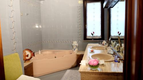 a bathroom with a tub and a sink at B&B Le Rose in Siderno Marina