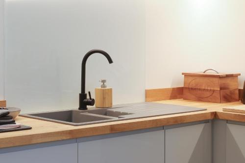 a kitchen with a sink and a counter top at Luxury 3-Bed Apartment - Sheffield City Centre - Netflix, WIFI, Radio, Interactive Mood Lighting, State of the Art in Sheffield