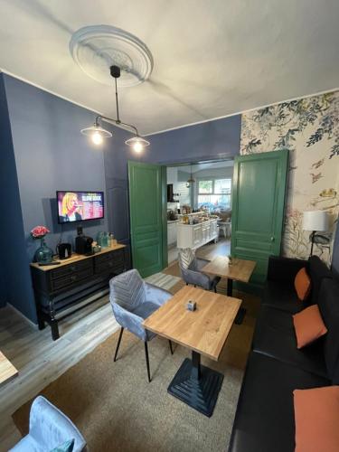 a living room with a couch and a table at Villa Artiz in Dunkerque