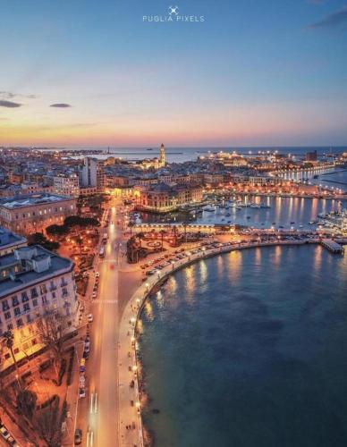 an aerial view of a city with a harbor at night at La Casa delle Tradizioni in Bari