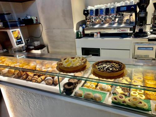 a bakery display case with many different types of pastries at La Casa delle Tradizioni in Bari