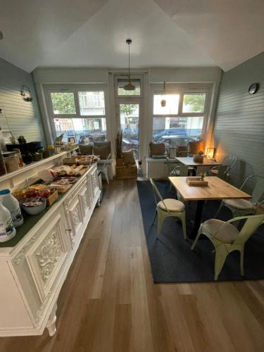 a restaurant with a counter with food on it at Villa Artiz in Dunkerque