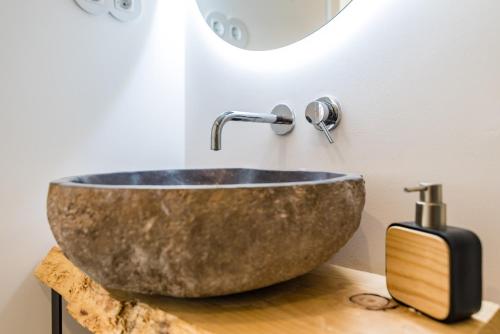 ein Badezimmer mit einem großen Steinwaschbecken auf der Theke in der Unterkunft Mermaid Cottage in Comporta