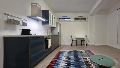 a kitchen with a rug on the floor and a table at Le Suites Moderne in Milan