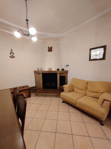 a living room with a couch and a fireplace at Villa Enrico in Monticchio