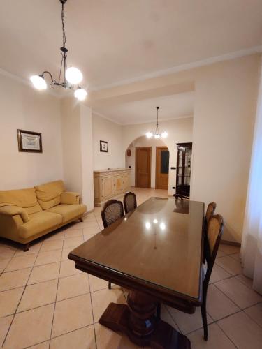 a living room with a table and a couch at Villa Enrico in Monticchio