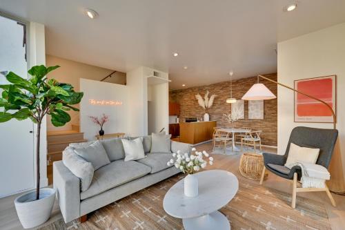 a living room with a couch and a table at Rooftop with Views Modern Little Italy Townhome in San Diego