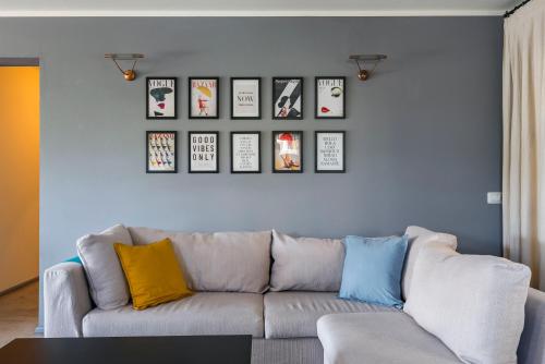 a living room with a couch and some pictures on a wall at La Magnanella - Luxury B&B in Fornovo di Taro